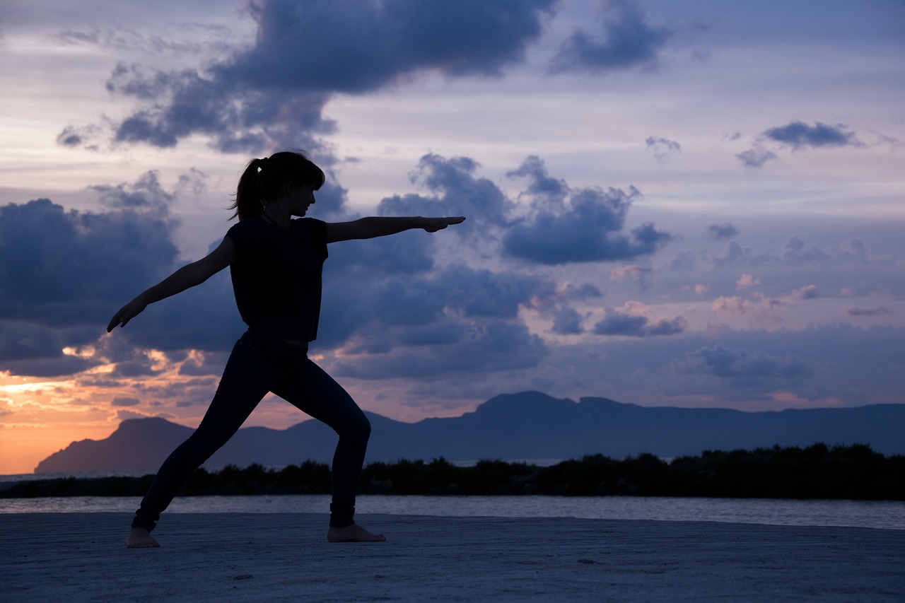 Girl doing yoga on the beach